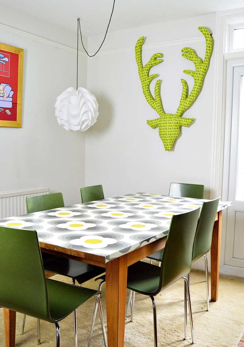 Revamp an old table with Orla Kiely wallpaper for that mid century modern look.