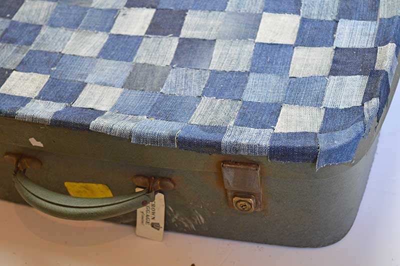 decoupaging the top of the suitcase with denim squares