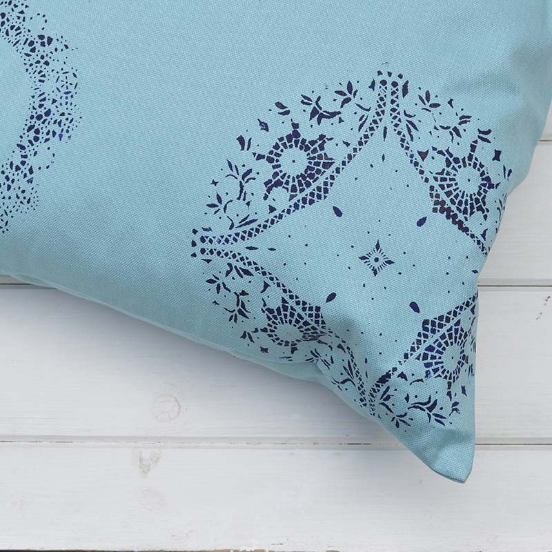 Brighten up your cushions by painting them using a doily as a stencil