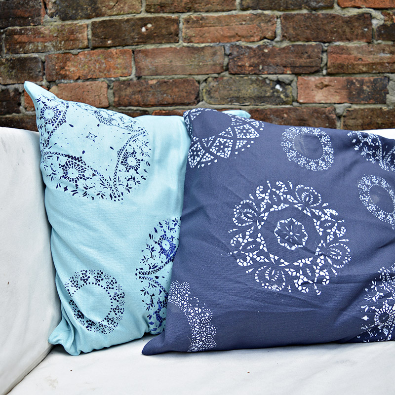 Brighten up your cushions by painting them using a doily as a stencil