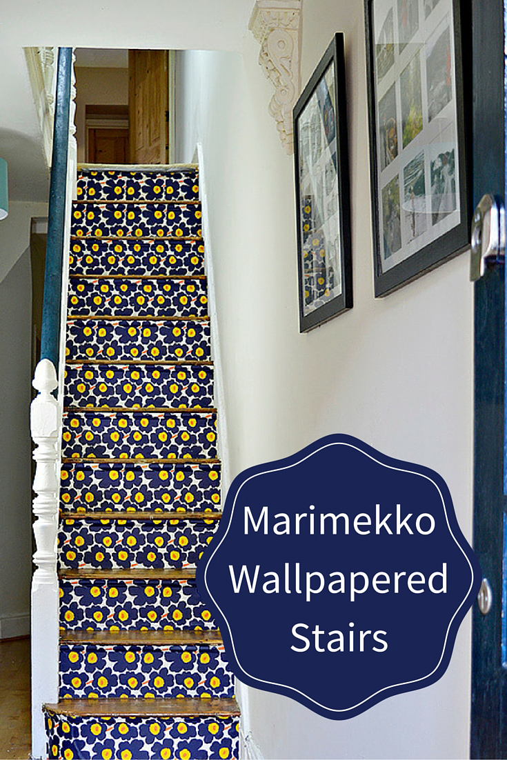 These stairs were transformed with Marimekko Unikko wallpaper.  Full tutorial on how to remove old carpet from stairs and how to wallpaper them for a more striking cleaner look.