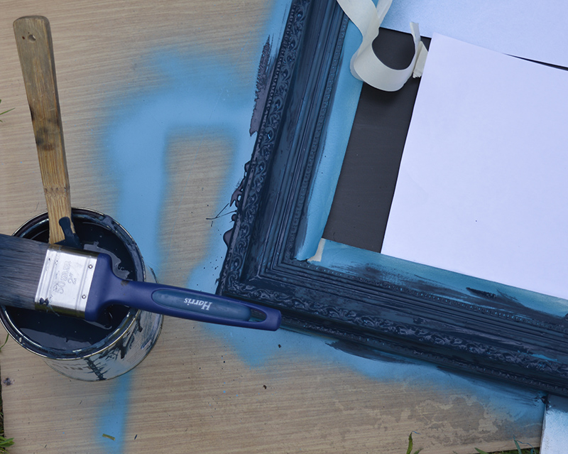 painting the frame with chalk paint in blue