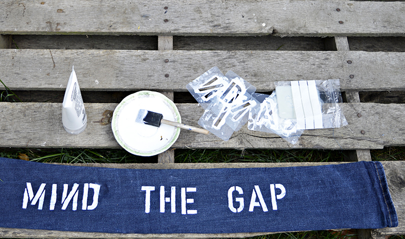 stenciling mind the gap on denim door snake