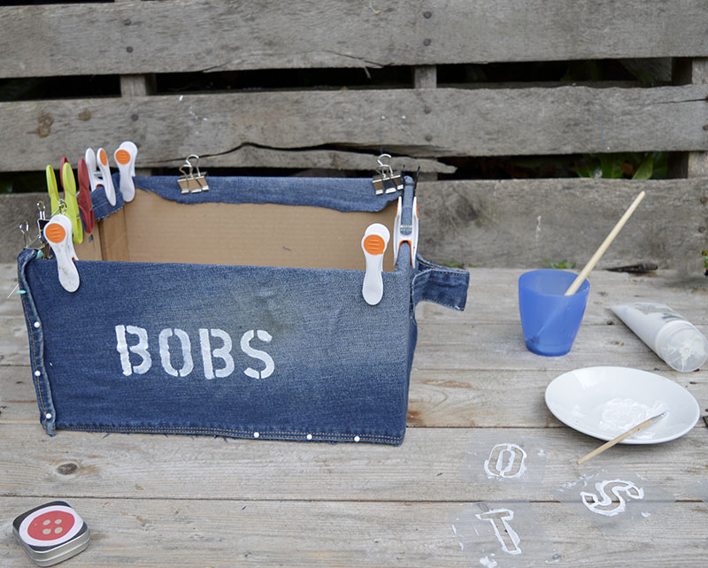 Stenciling denim storage boxes.