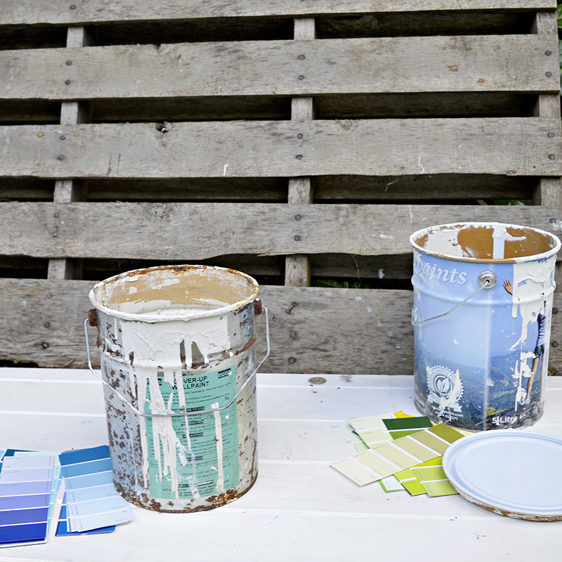 Upcycled empty paint cans with paint chips.  Great colour coded storage for craft room.