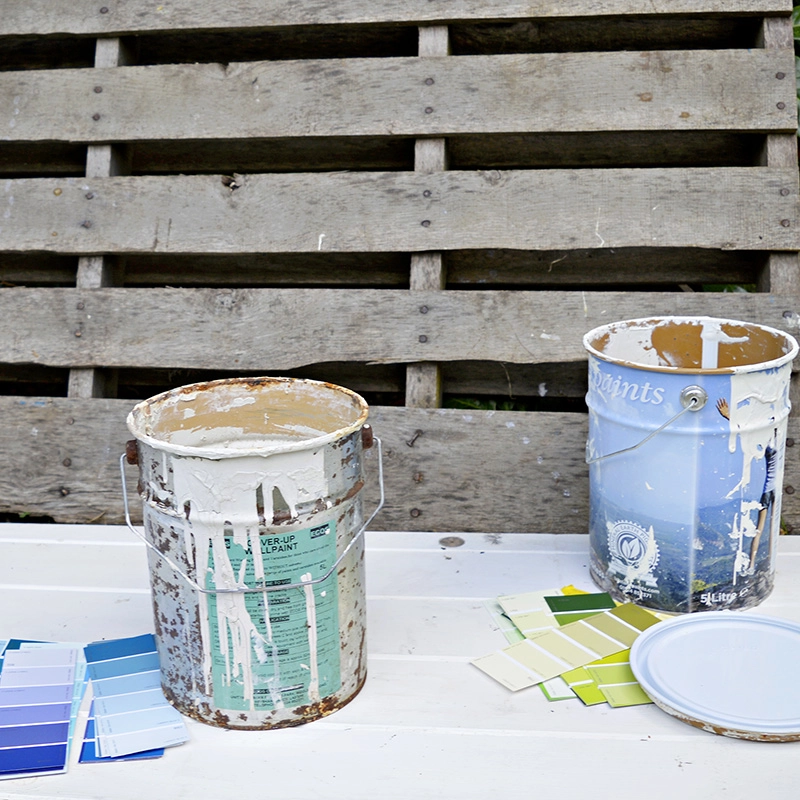 Upcycled empty paint cans with paint chips.  Great colour coded storage for craft room.