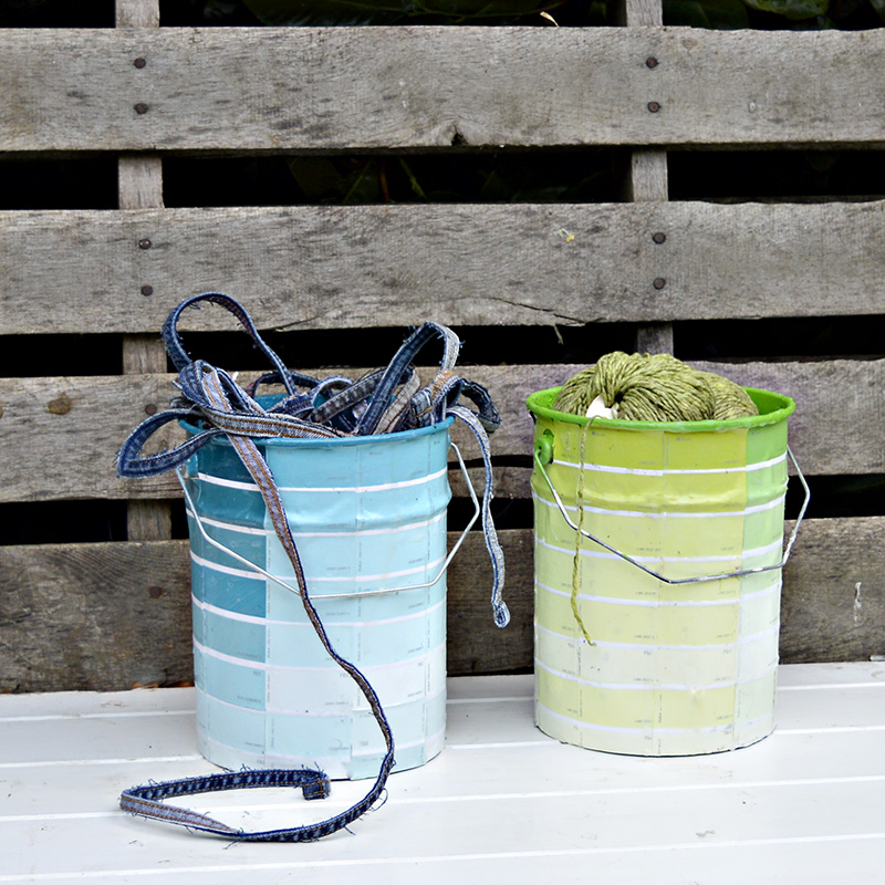 Upcycled empty paint cans with paint chips.  Great colour coded storage for craft room.