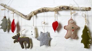 These are super cute upcycled Christmas ornaments. Made with old sweaters and cookie cutter shapes. Make for a lovely Christmas wall decoration.