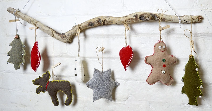 These are super cute upcycled Christmas ornaments. Made with old sweaters and cookie cutter shapes. Make for a lovely Christmas wall decoration.