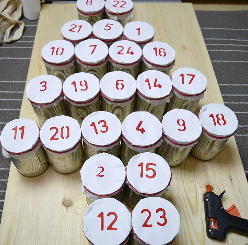 arangement of upcycled tin can advent calendar