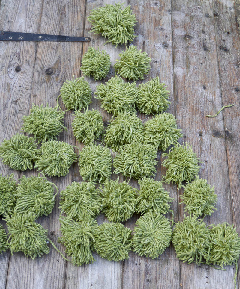 Arranging the pom poms into a Christmas shape