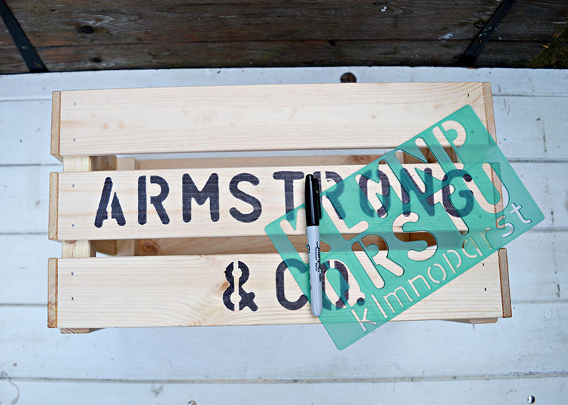 Stenciling a crate with a sharpie