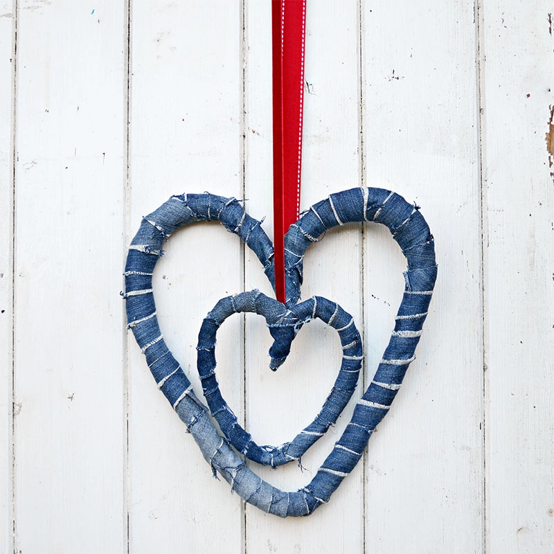 Use your old jeans and a coat hanger to make a gorgeous upcycled denim wreath for Valentines or all year round decor.