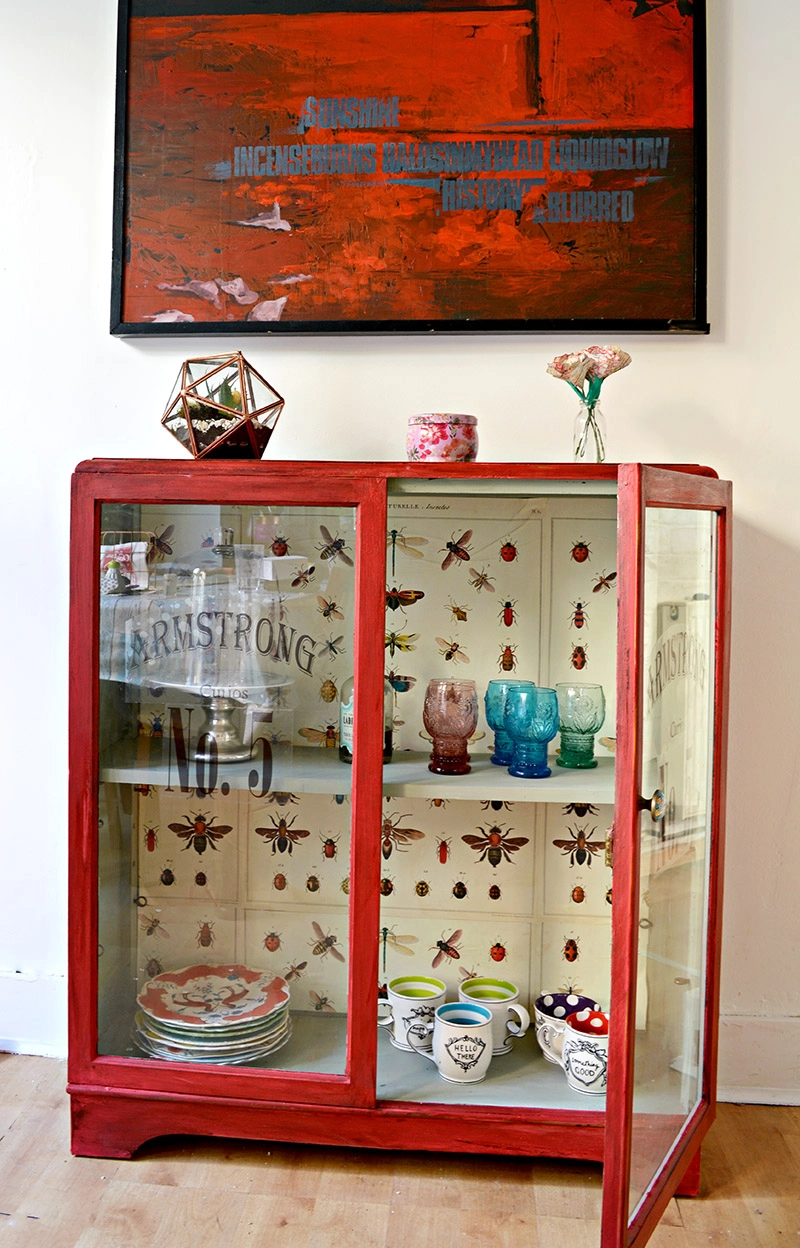 The best chalk paint cupboard upcycle with Annie Sloan Red Emperors Silk, decoupaged vintage graphics (Cavallini's insect wrap) and printable window decals.  Full tutorial.