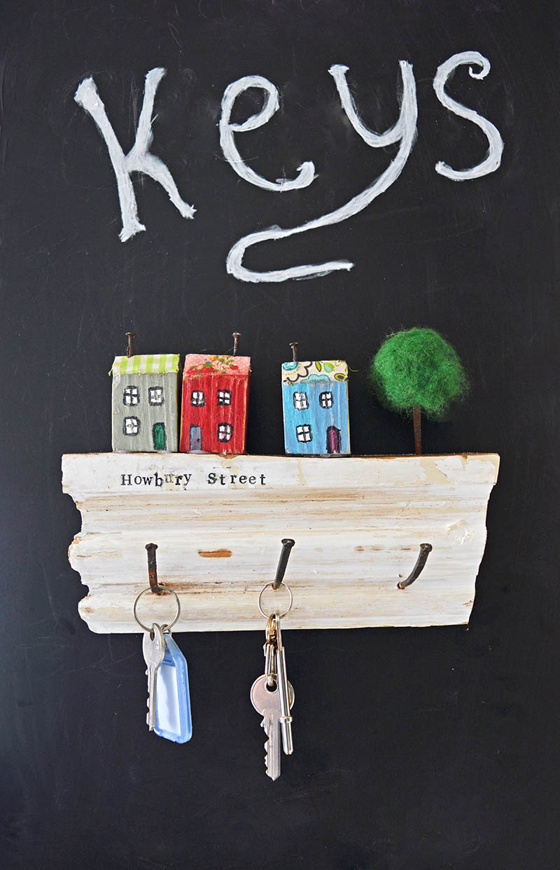 Use some pieces of scrap wood and nails to make this cute handy upcycled wall key holder.  It would make a lovely gift as you can personalize it with your street name.