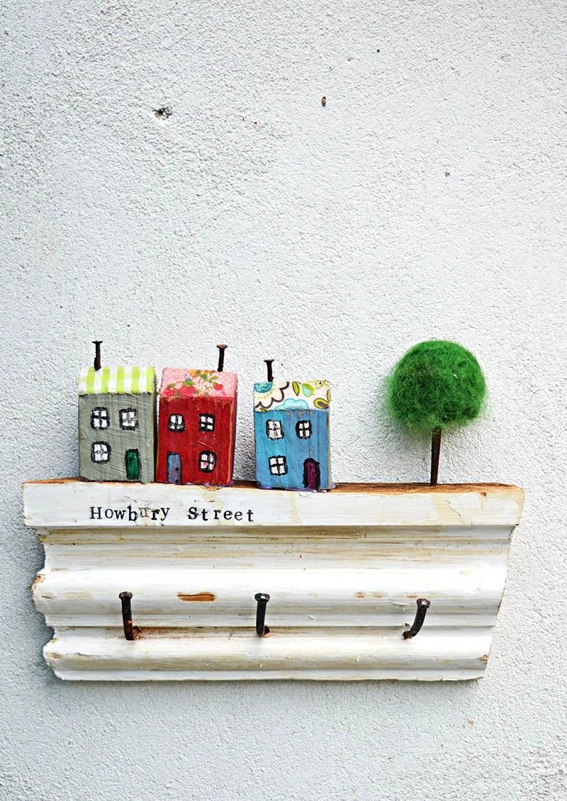 Make a cute wall key holder out of scrap wood from your house and stamp your street name on the rack.  For a unique cute quirky and useful key rack.