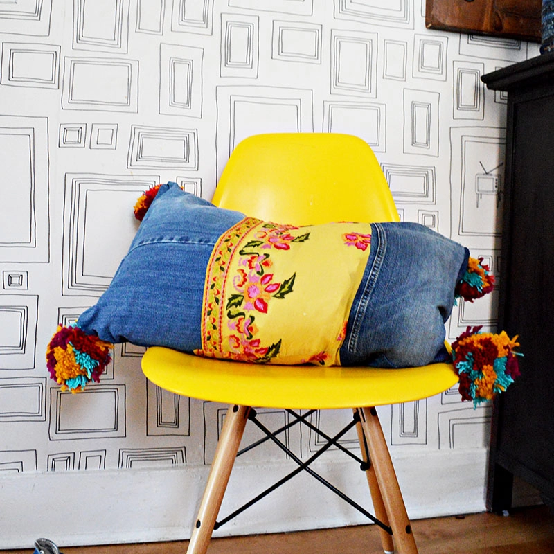 DIY boho style recycled jeans pillows with pom poms and vintage sari trim.
