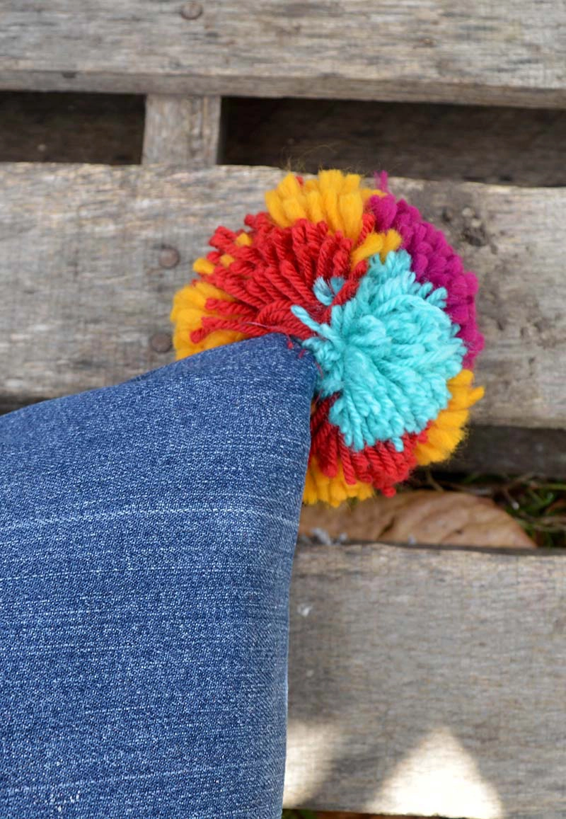 stitching pom pom onto jeans pillows