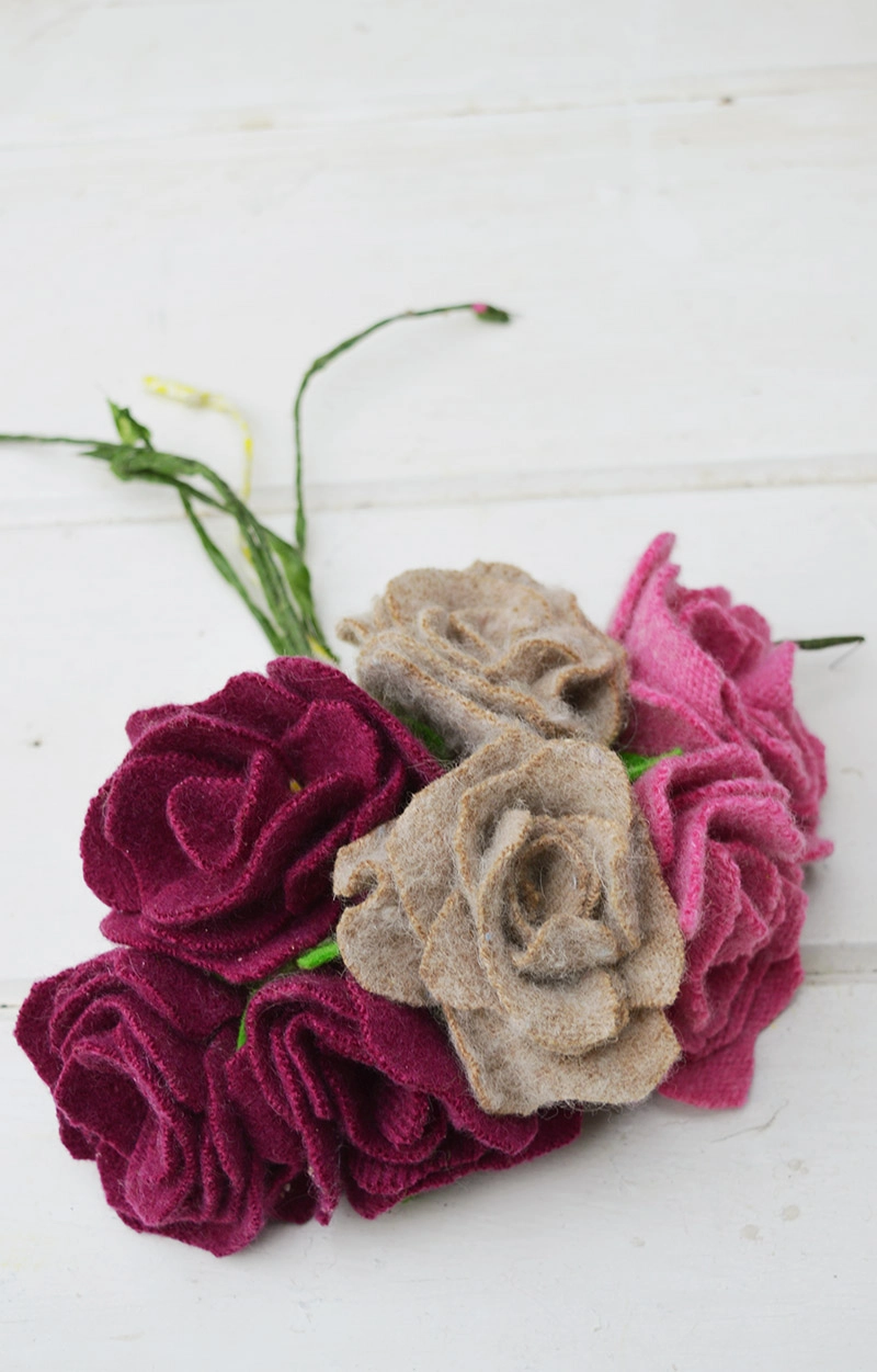 Upcycled felted wool sweater scraps made into felt roses for a gorgeous door wreath decoration.