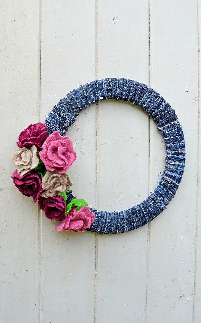 This gorgeous denim wreath is made by using old wool sweaters and recycled jeans seams.  It is very simple to make with a great step by step tutorial.