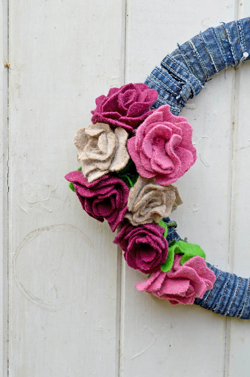 This gorgeous denim wreath is made by using old wool sweaters and recycled jeans seams.  It is very simple to make with a great step by step tutorial.
