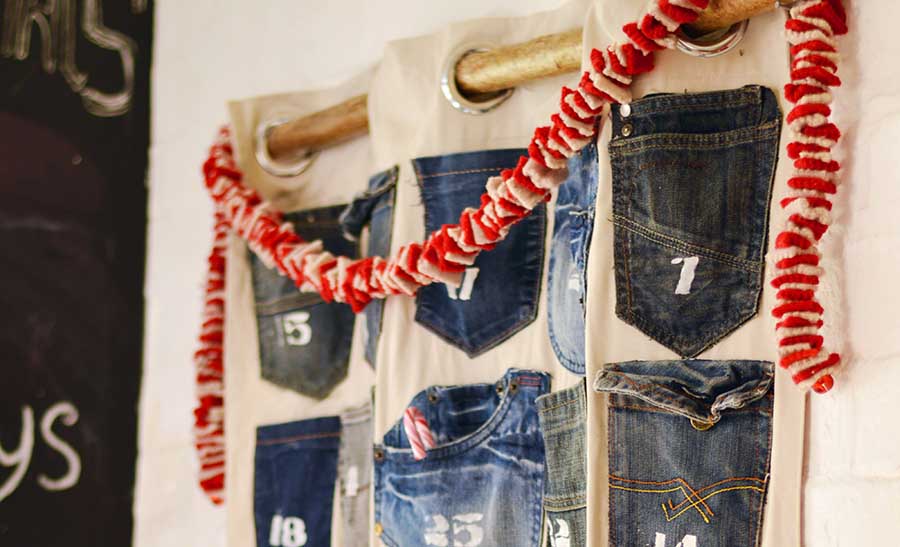 Rustic, industrial homemade advent calendar. This is easy to make Christmas craft from recycled jeans pockets and is a no-sew project.