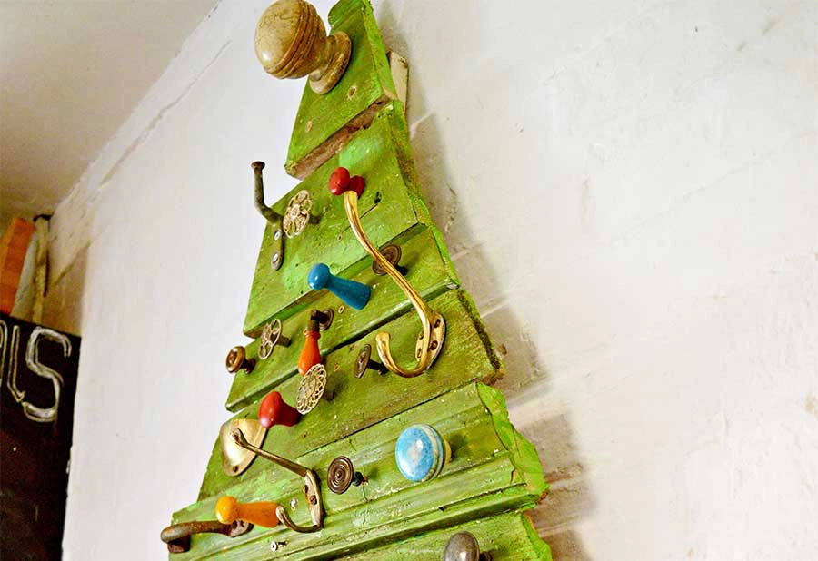 Upcycled flat Christmas tree made from reclaimed wood and cabinet knobs and hooks.