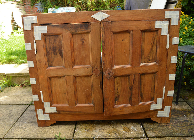 Masking tape covered cupboard