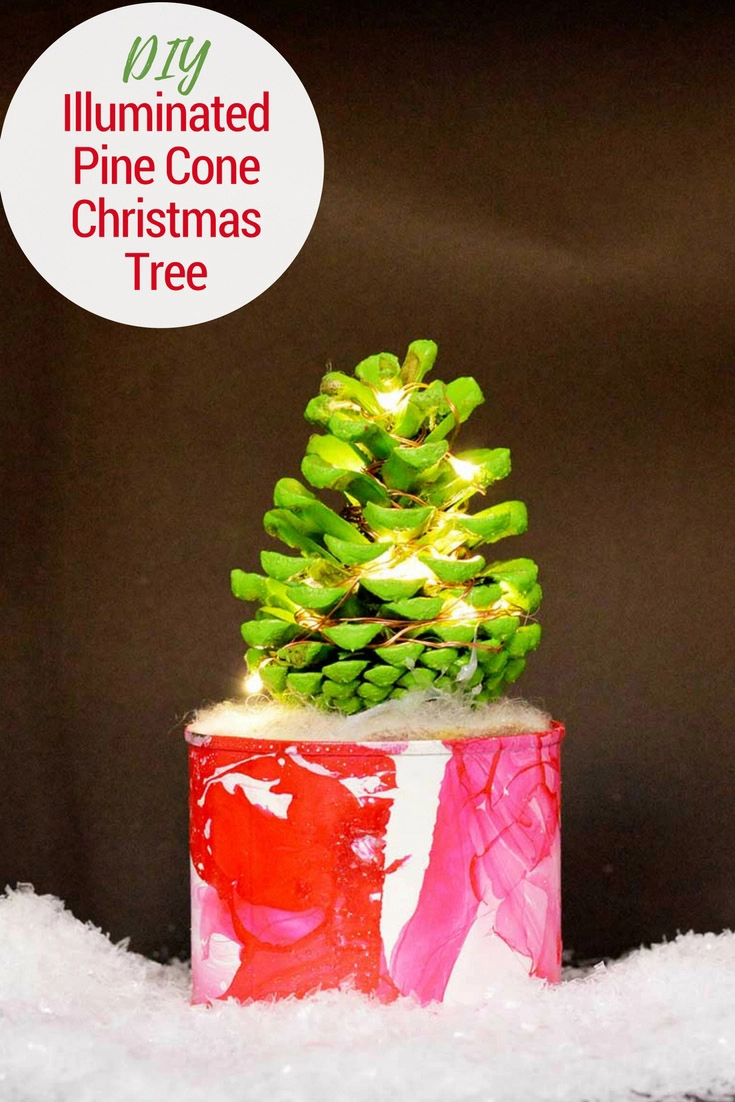 How to make a cute illuminated pine cone Christmas tree in a marble pot. This colorful Christmas tree complete with copper lights will brighten up any desk. #christmascrafts #christmas #pinecone #christmaslights