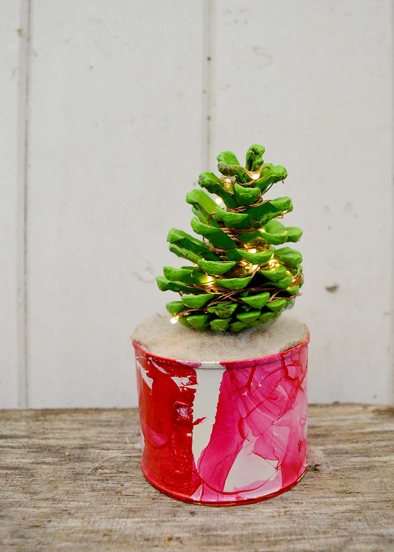 Cute illuminated desk top pine cone Christmas tree ornament.