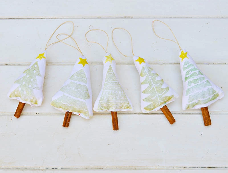 Printed cinnamon Christmas tree decorations made with a handmade Christmas stamp.