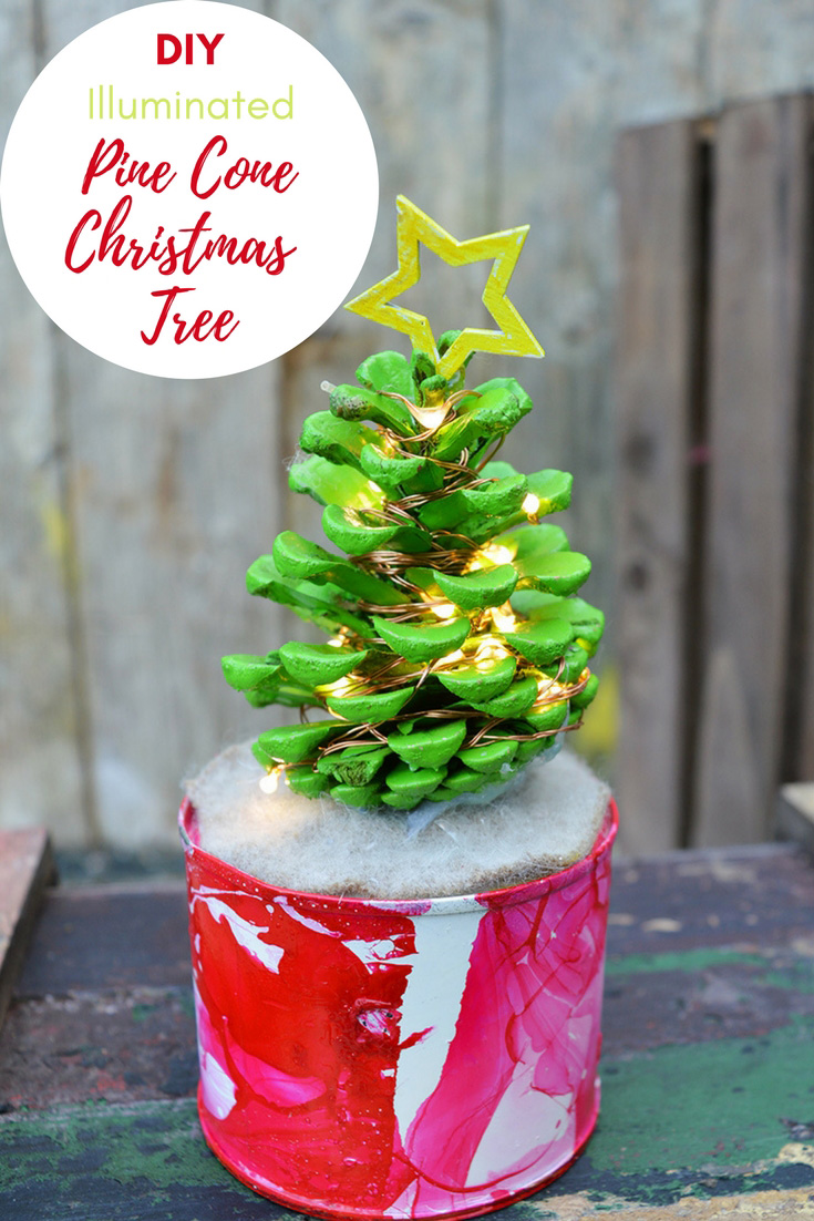 How to make a cute illuminated pine cone Christmas tree in a marble pot. This colorful Christmas tree complete with copper lights will brighten up any desk. #christmascrafts #christmas #pinecone #christmaslights