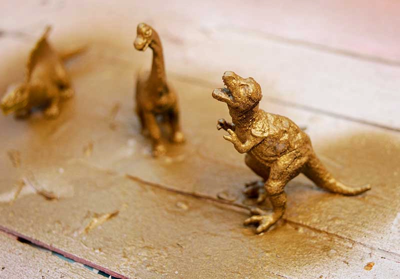 Gold spray painted dinosaur