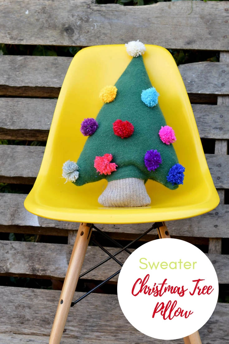 Make a really cute Christmas tree pillow from an old green sweater. Add fun and colourful decorations to the sweater tree with pom poms. #Christmascraft #sweater #Christmaspillow #repurposed #upcycle #pompom