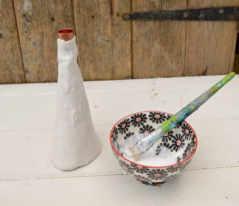 Sealing the clay candle holders.