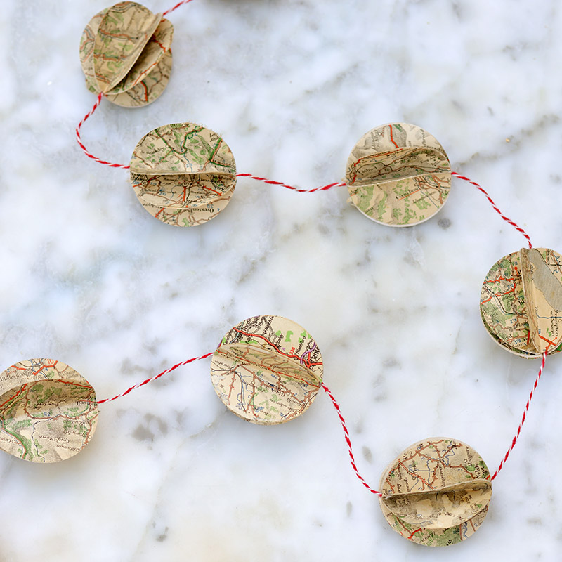 Upcycle old road maps to make a gorgeous DIY map decorations in the form of a garland.