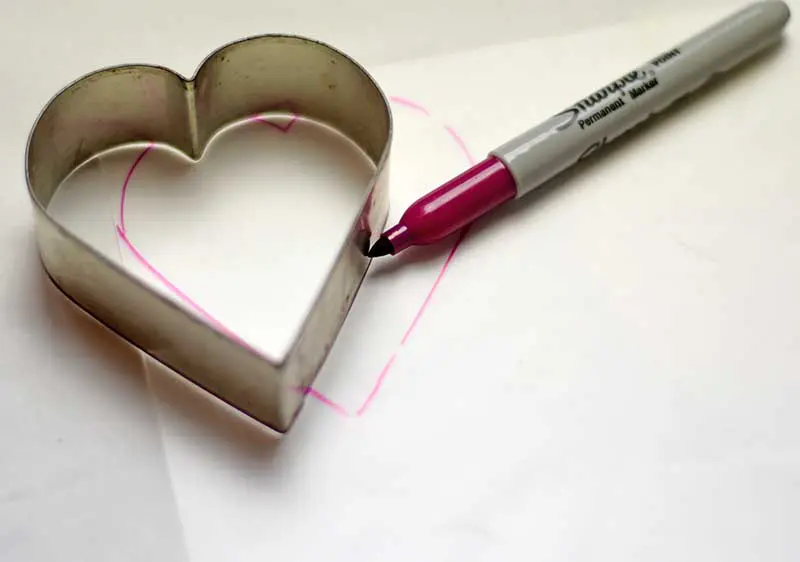 Drawing around heart cookie cutter