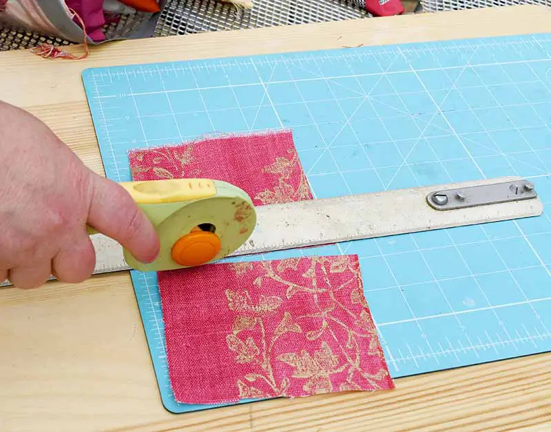 Cutting fabric scraps on mat