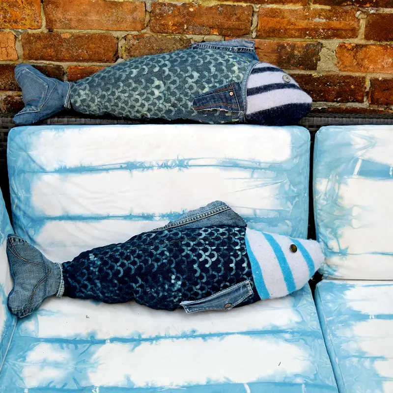 Repurposed denim fish pillows on Shibori dyed sofa.