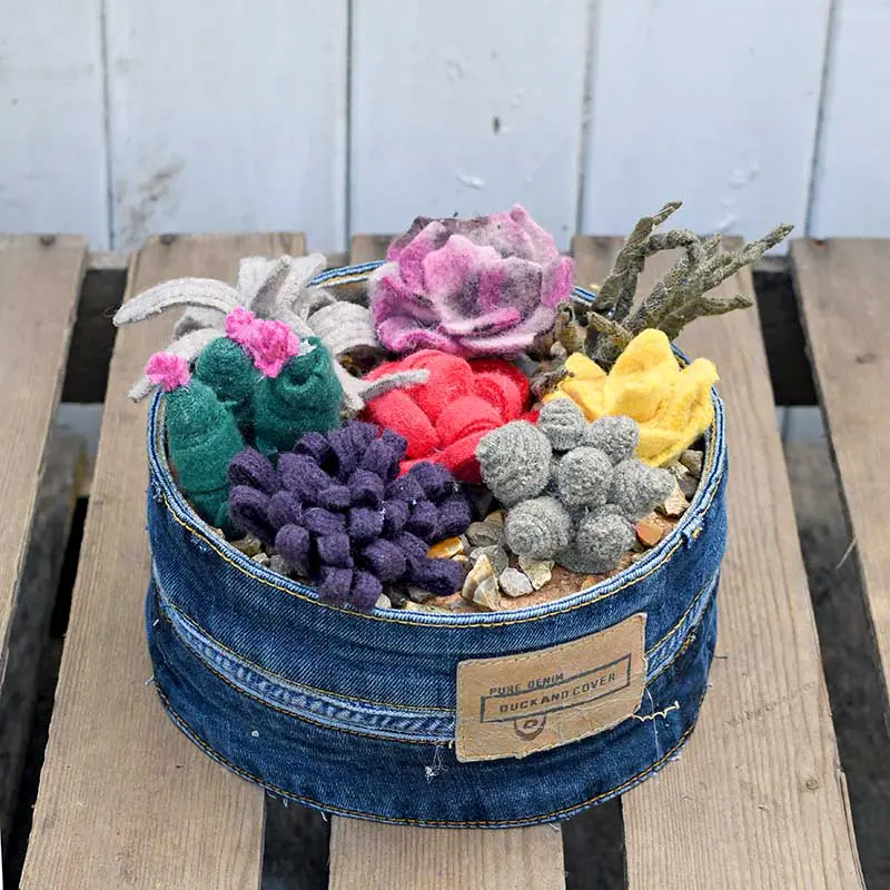 Upcycled sweater felt scraps into a faux succulent garden in repurposed jean planter