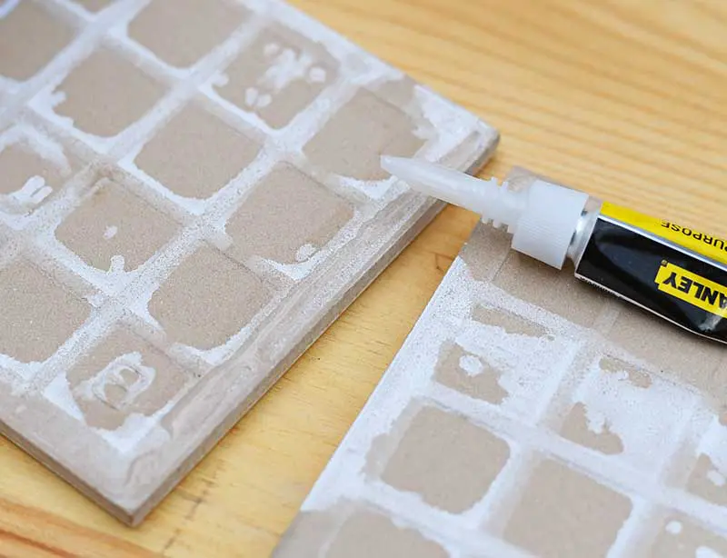 Applying superglue to the tile edge.