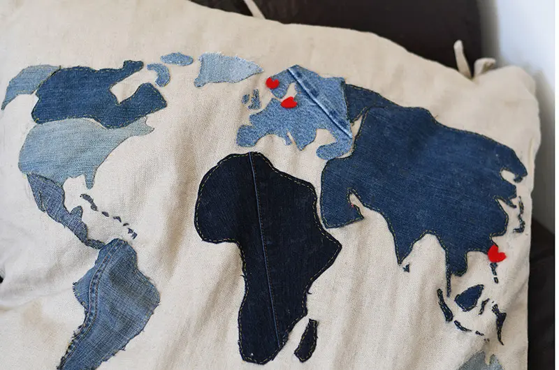 applique denim world map pillow close up 