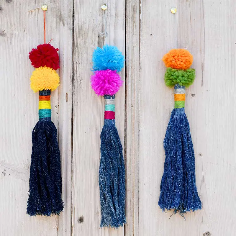 Upcycled denim tassels with pom poms