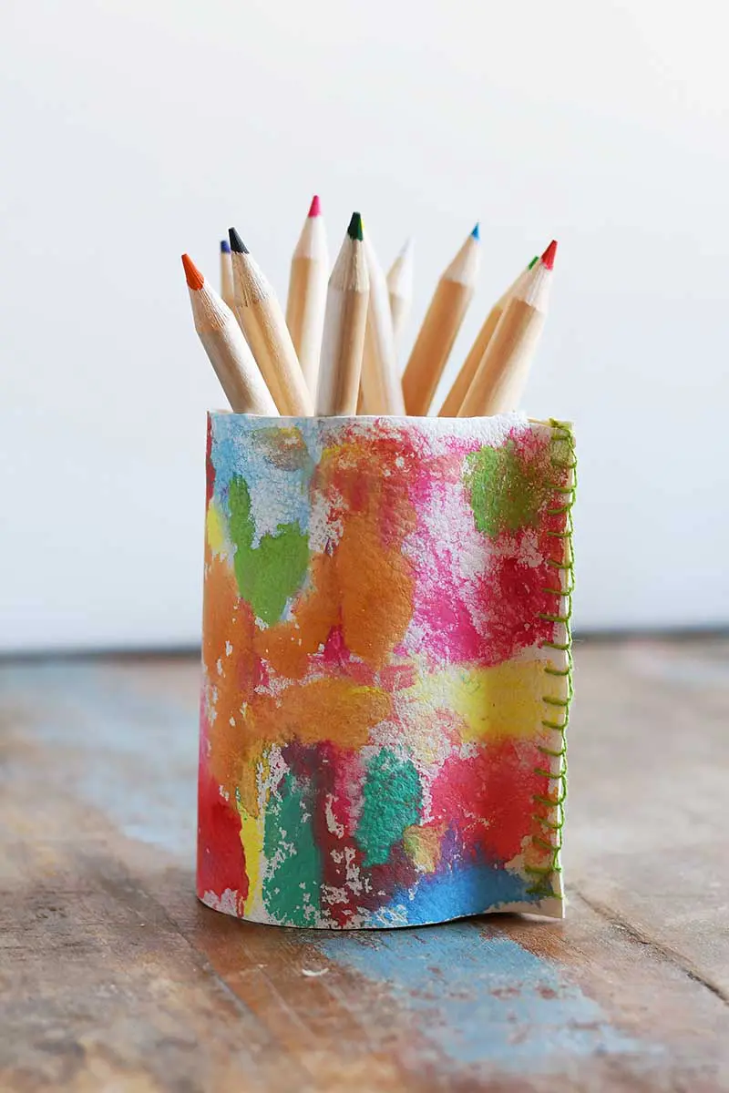 Upcycled tin can into a rainbow leather pen pot