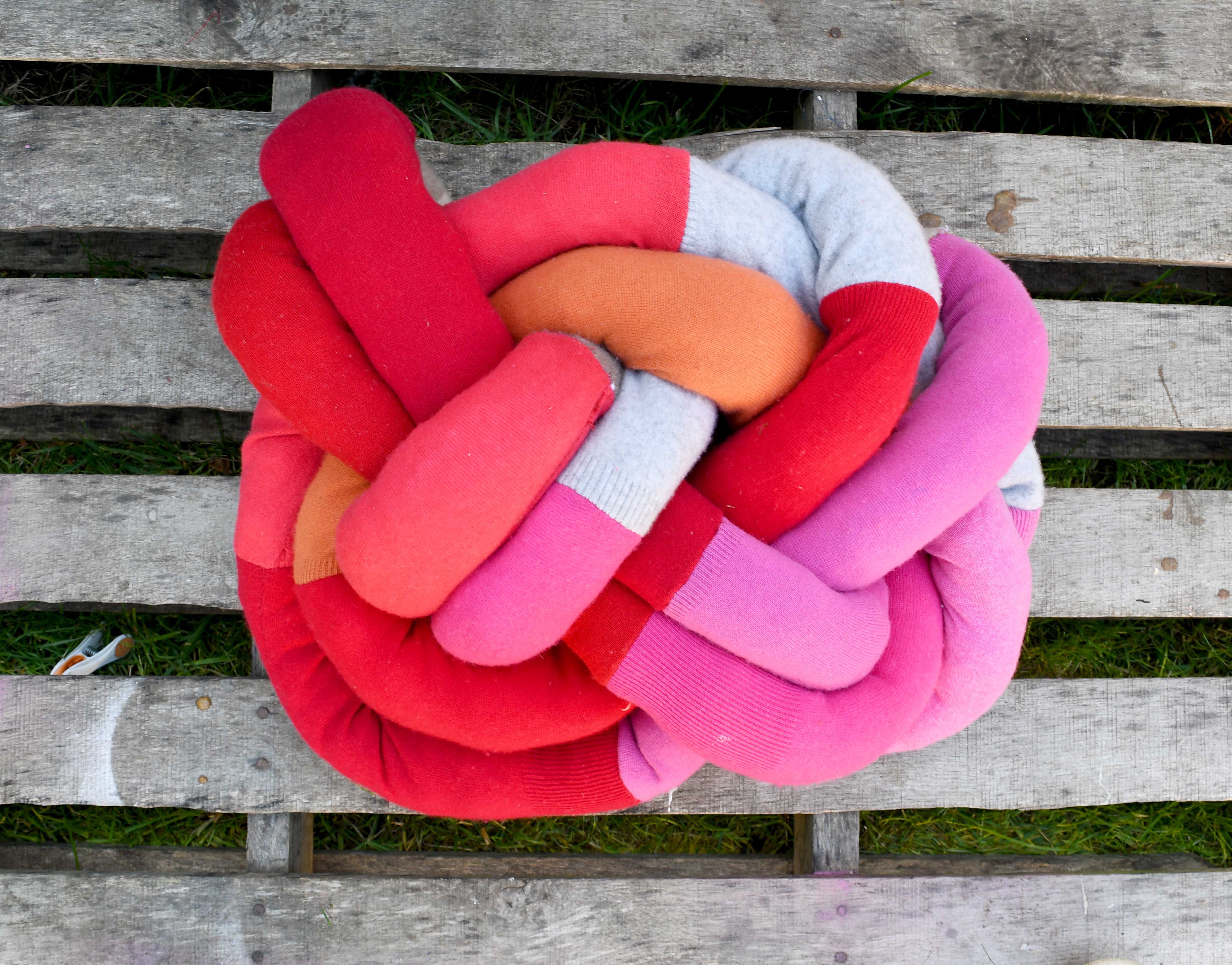 DIY upcycled sweater knot pillow