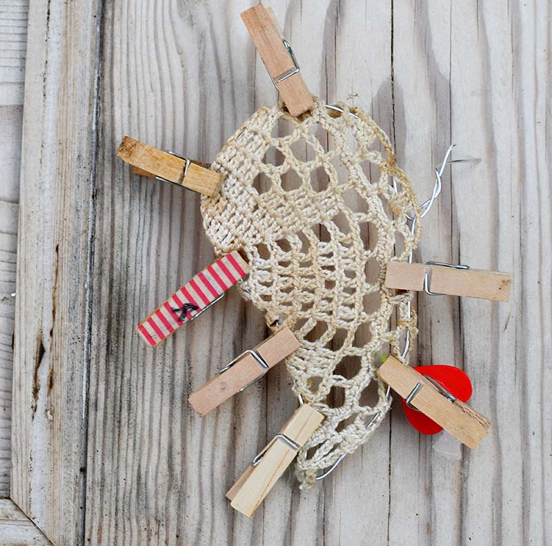 Holding doily in place with pegs