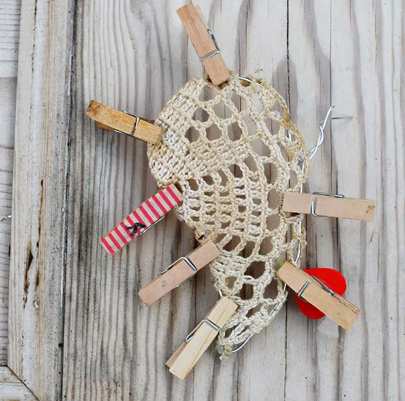 Holding doily in place with pegs