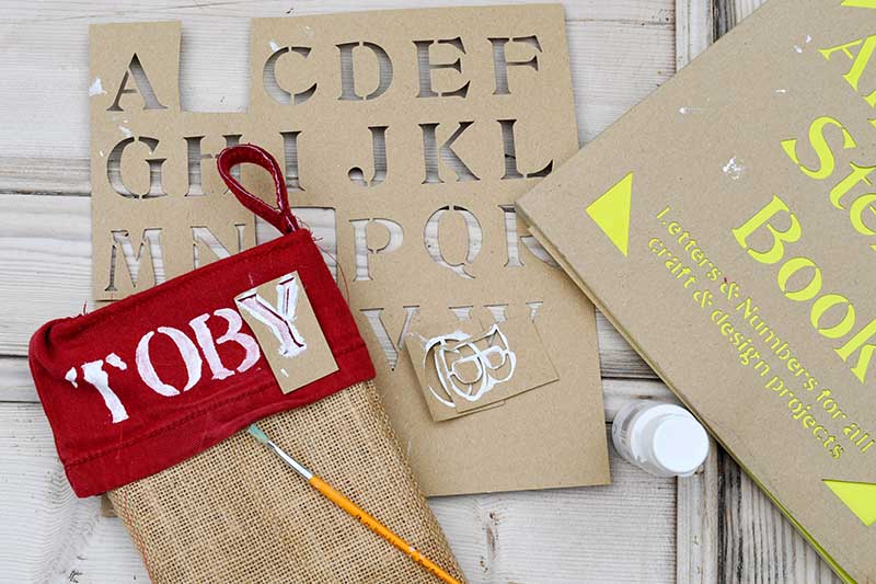 Stencilling pet name onto dog Christmas stocking