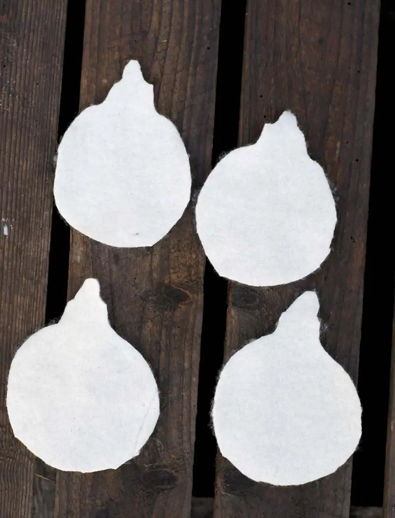 Cut white felt bauble shapes