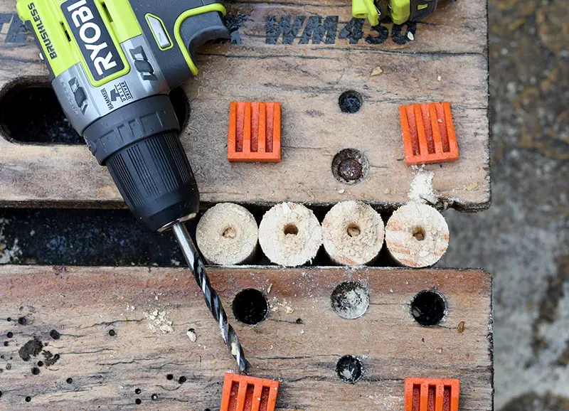 Drilling holes in the wooden thistle decoration vases.
